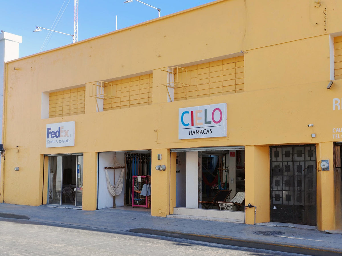 Yellow façade of the CIELO store and offices on Calle 65 in central Mérida.