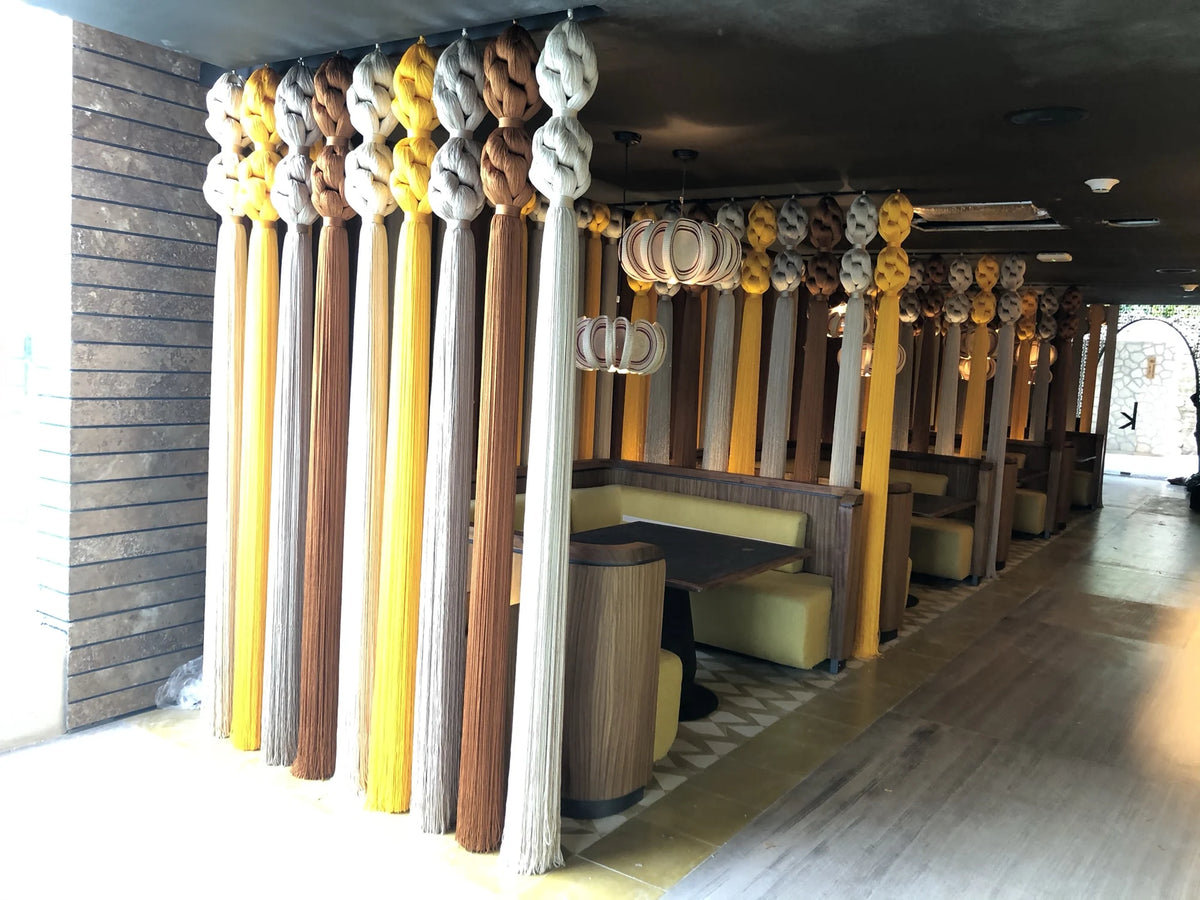 Pale, yellow and brown textile partitions between the tables at Kibi Kibi.